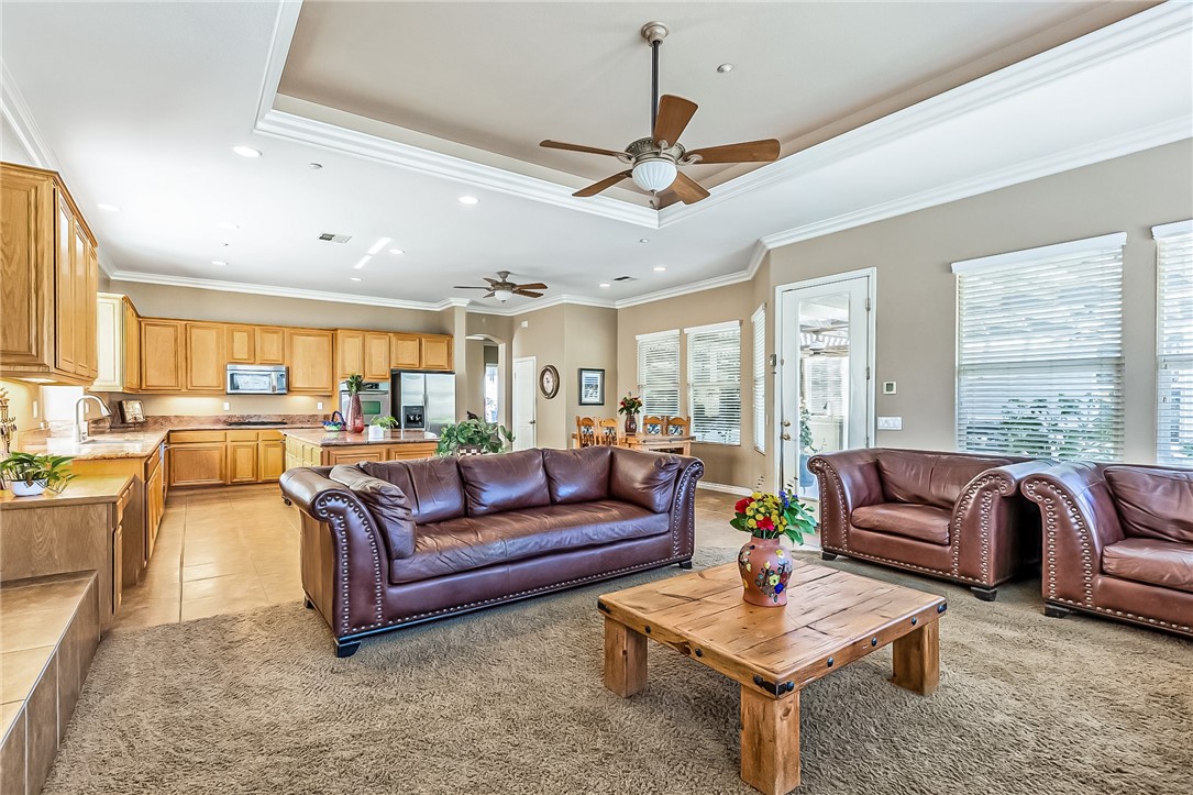 3047 Dapplegray Lane Norco, CA 92860 - Photo 12 of 28 a living room with furniture a ceiling fan and a large window