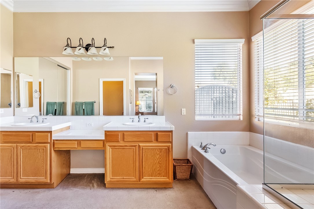 3047 Dapplegray Lane Norco, CA 92860 - Photo 20 of 28 a bathroom with a tub a double vanity sink and a large mirror