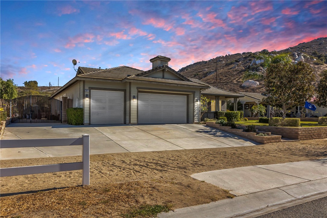 3047 Dapplegray Lane Norco, CA 92860 - Photo 4 of 28 a front view of a house with a yard and a garage