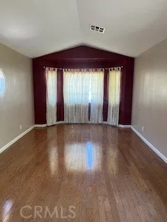 a living room with a fireplace and a floor to ceiling window