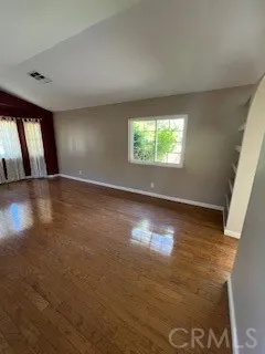 a large white kitchen with granite countertop a stove top oven a sink and a fireplace