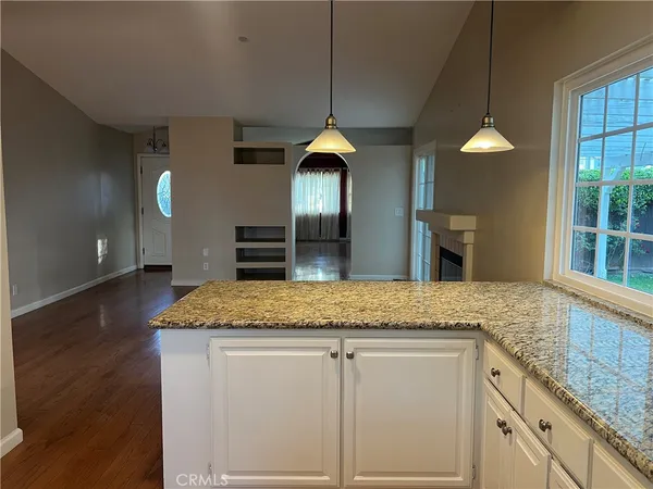 a kitchen with granite countertop a sink stainless steel appliances and cabinets
