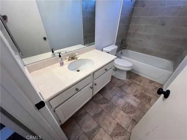 a white toilet sitting next to a bathroom sink
