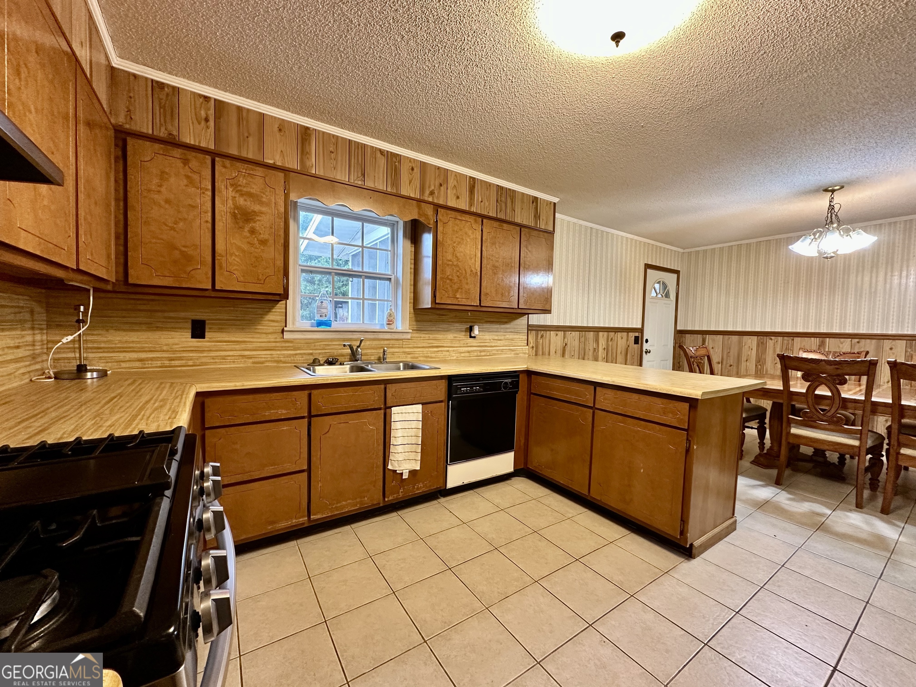 74 Community Church Road McRae-Helena, GA 31037 - Photo 15 of 31 a kitchen with stainless steel appliances granite countertop a stove a sink and a microwave