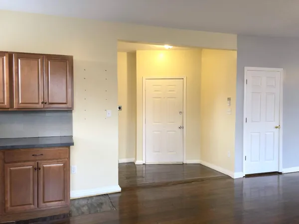 a kitchen with granite countertop wooden floors and stainless steel appliances