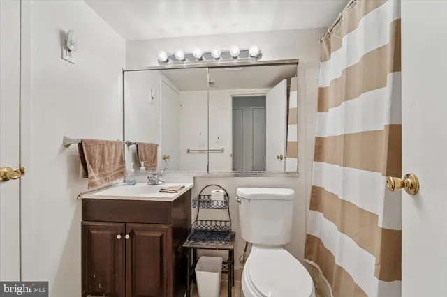 a bathroom with a toilet a sink and a mirror