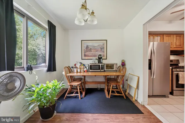 a dining room with furniture potted plants and wooden floor
