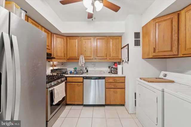 a kitchen with a stove sink and cabinets