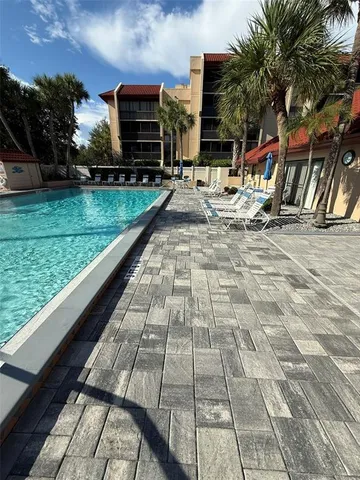 a view of swimming pool with sitting area