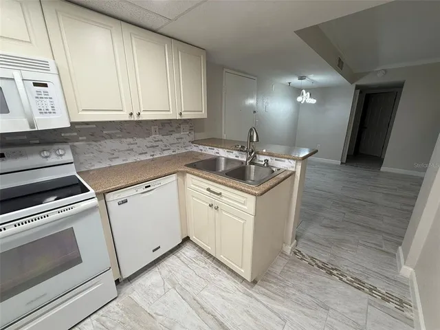 a kitchen with a sink stove and cabinets