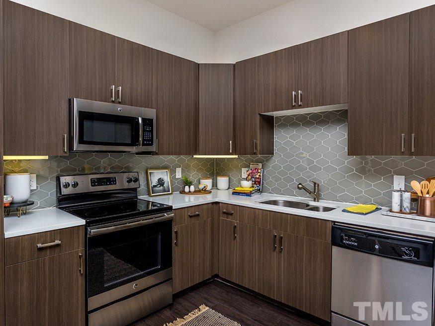 4700 Riverwood Circle, Unit 268 Raleigh, NC 27612 - Photo 11 of 22 a kitchen with a sink stove top oven and cabinets