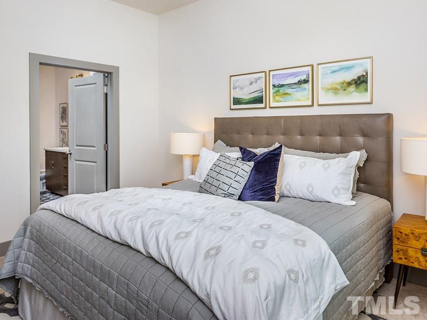 4700 Riverwood Circle, Unit 268 Raleigh, NC 27612 - Photo 13 of 22 a bedroom with a bed and painting on the wall