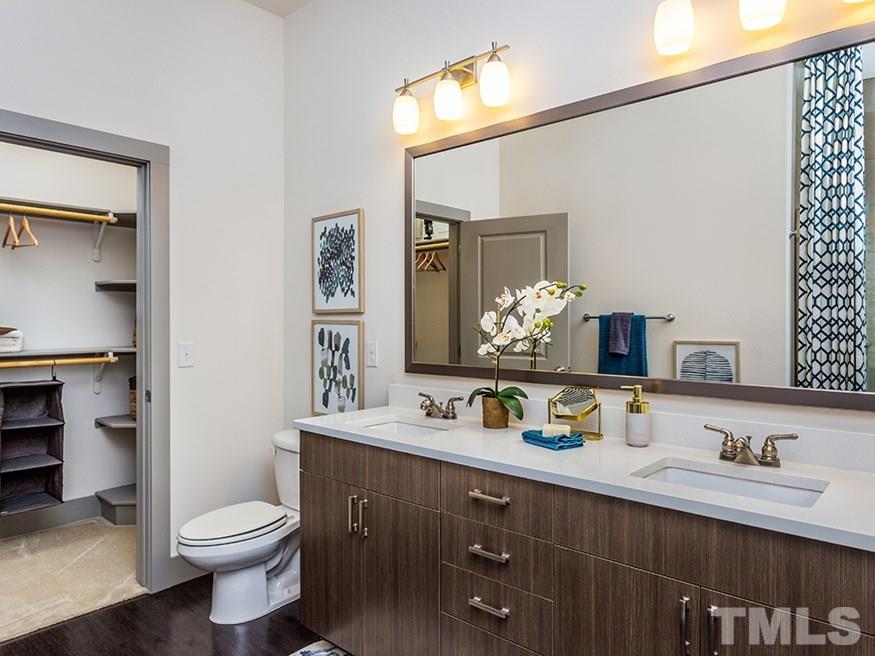 4700 Riverwood Circle, Unit 268 Raleigh, NC 27612 - Photo 14 of 22 a bathroom with a toilet sink and mirror