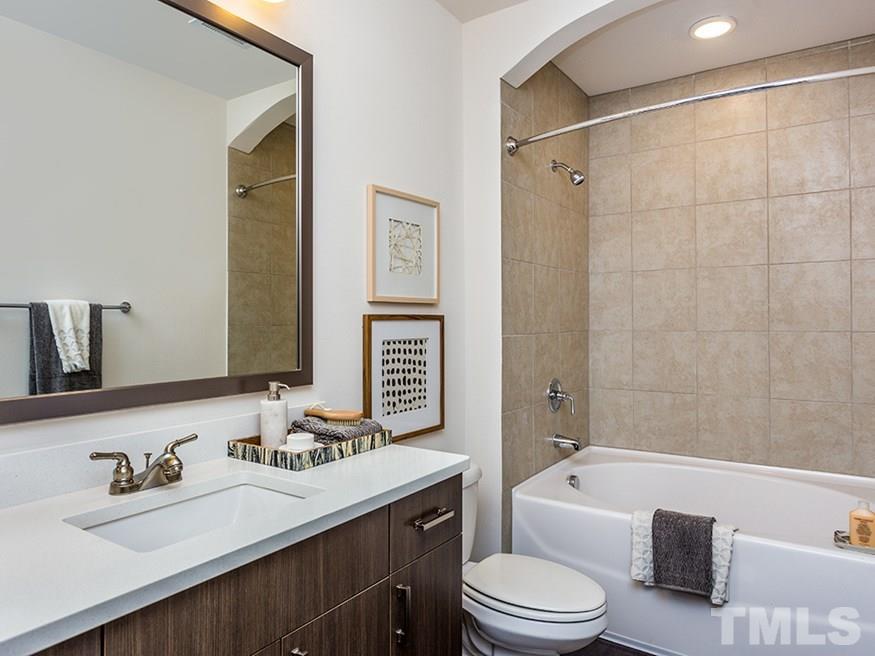 4700 Riverwood Circle, Unit 268 Raleigh, NC 27612 - Photo 15 of 22 a bathroom with a granite countertop sink toilet tub and shower