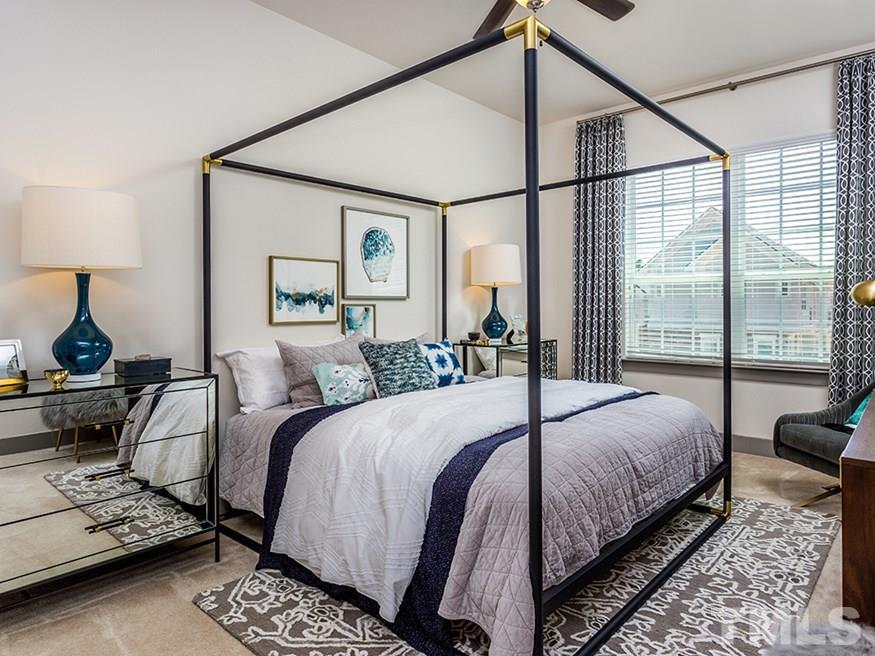 4700 Riverwood Circle, Unit 268 Raleigh, NC 27612 - Photo 19 of 22 a bedroom with a bed window and a night stand