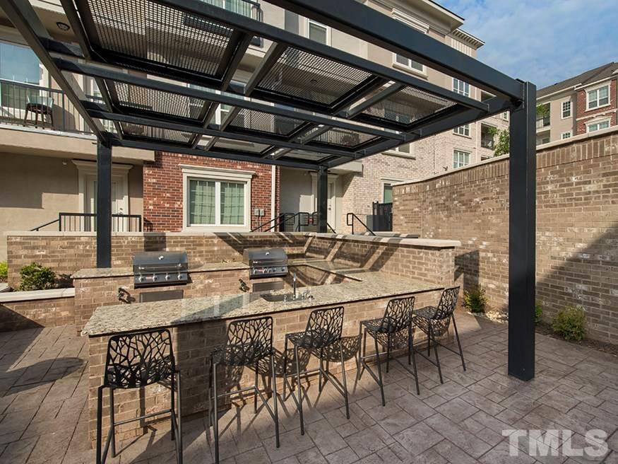 4700 Riverwood Circle, Unit 268 Raleigh, NC 27612 - Photo 8 of 22 a outdoor dining area with chairs and tables