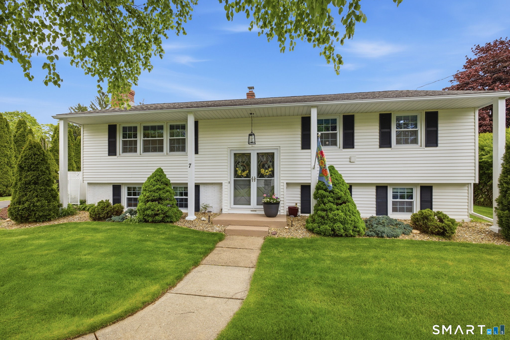7 Stardust Drive Enfield, CT 06082 - Photo 1 of 38 a front view of a house with a yard and porch