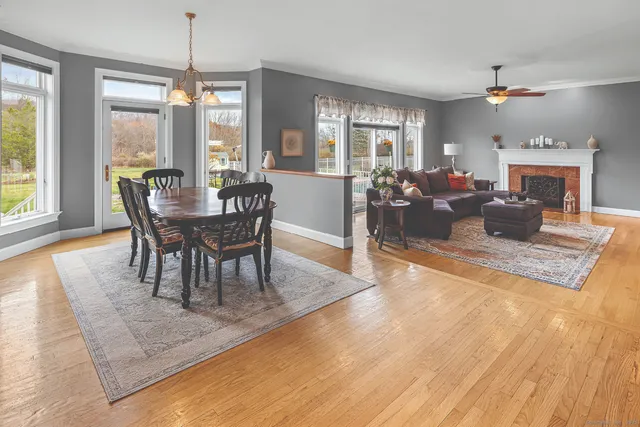 a view of a dining room with furniture window and wooden floor