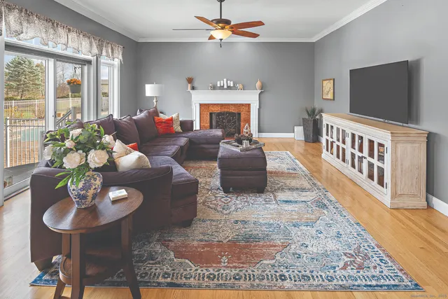 a living room with furniture a fireplace and a flat screen tv