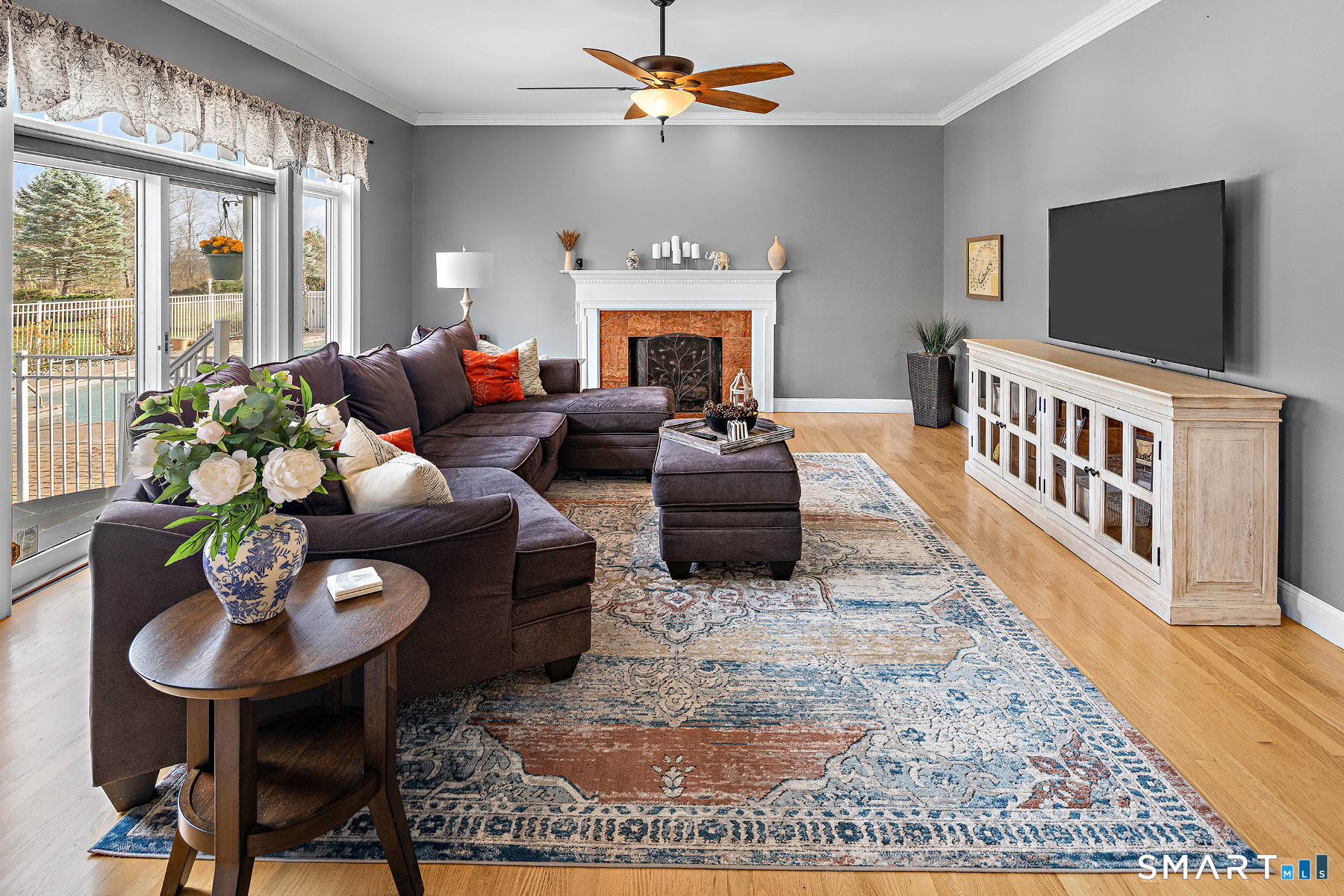 16 Marie Lane Wallingford, CT 06492 - Photo 21 of 40 a living room with furniture a fireplace and a flat screen tv