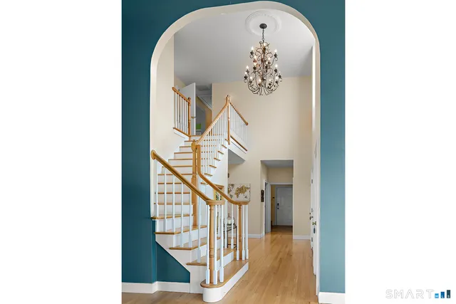 a spacious bedroom with a bed and a chandelier