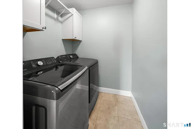 a bathroom with a granite countertop toilet sink and mirror