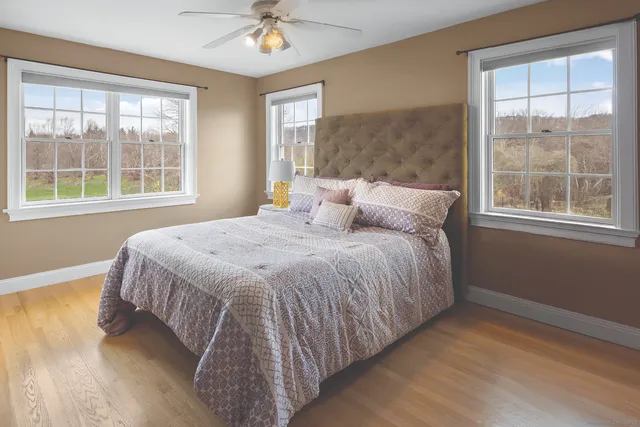 a bedroom with a bed and a window