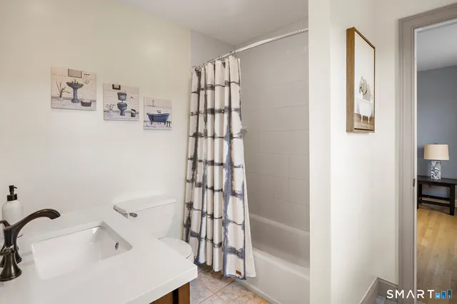 a bedroom with a bed wooden floor and window