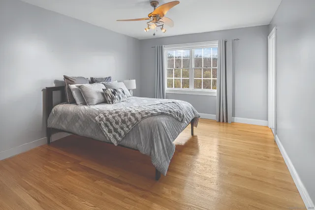 a spacious bedroom with a bed and a window