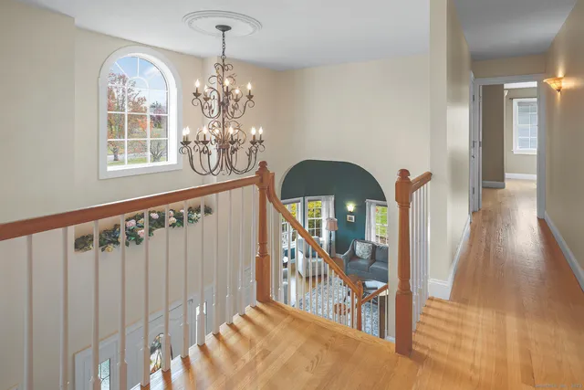 a view of a livingroom with wooden floor and windows