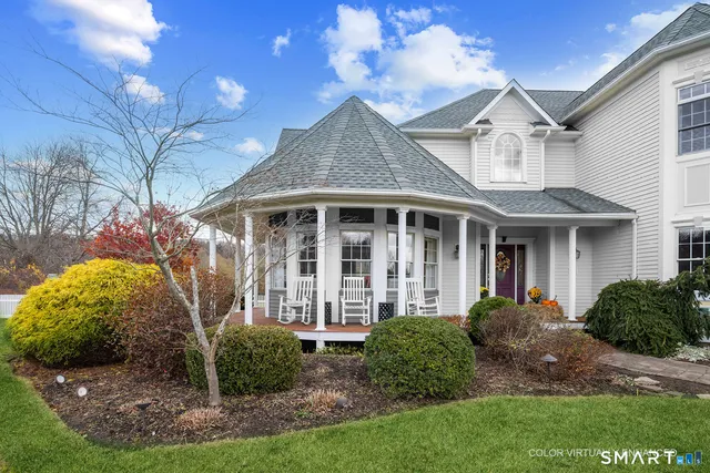 a view of a brick house with a yard and plants