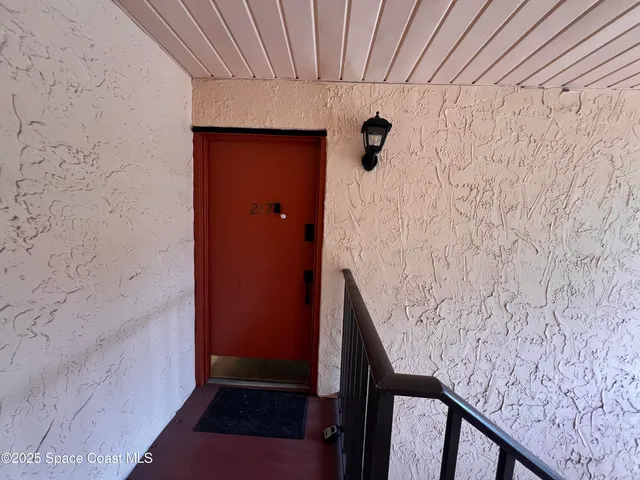 a view of wooden staircase with white walls