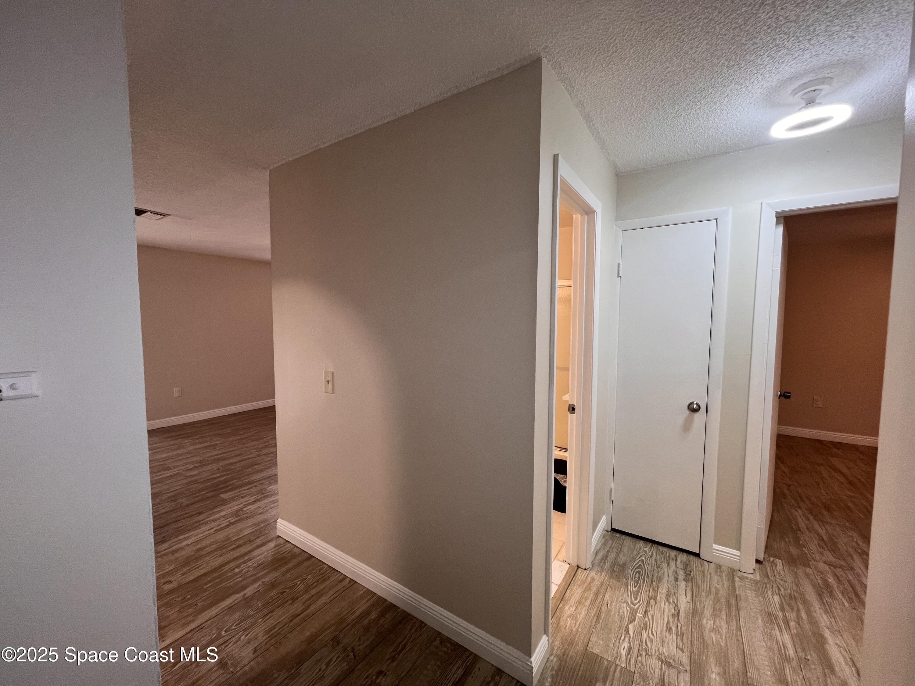 217 San Juan Circle Melbourne, FL 32935 - Photo 3 of 9 a view of hallway with wooden floor