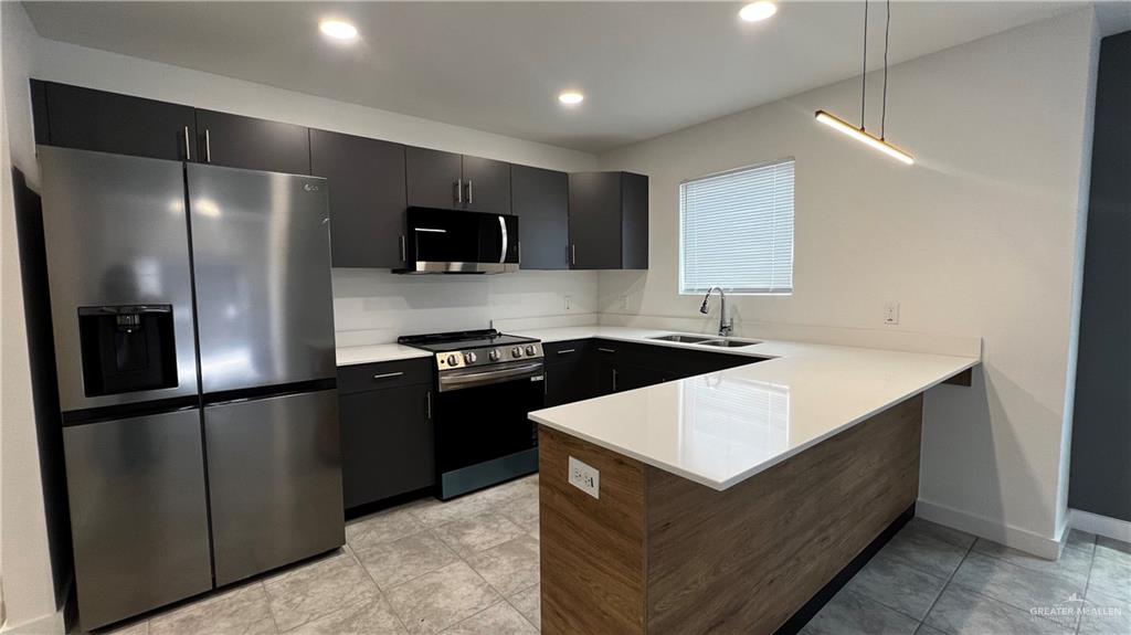 4004 Jenna Lane, Unit A Weslaco, TX 78599 - Photo 8 of 29 a kitchen with stainless steel appliances granite countertop a refrigerator a sink and a stove