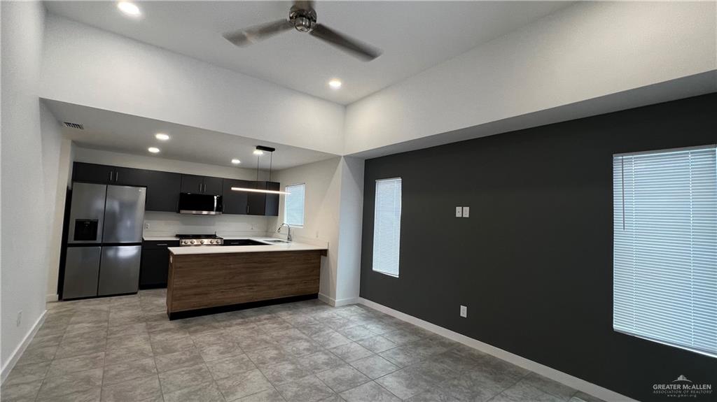 4004 Jenna Lane, Unit A Weslaco, TX 78599 - Photo 9 of 29 a kitchen with stainless steel appliances granite countertop a refrigerator and a stove top oven