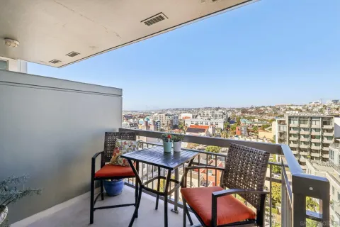 a view of a chairs and table in a balcony
