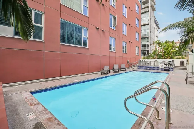 a view of multi story residential apartment building with a yard and plants