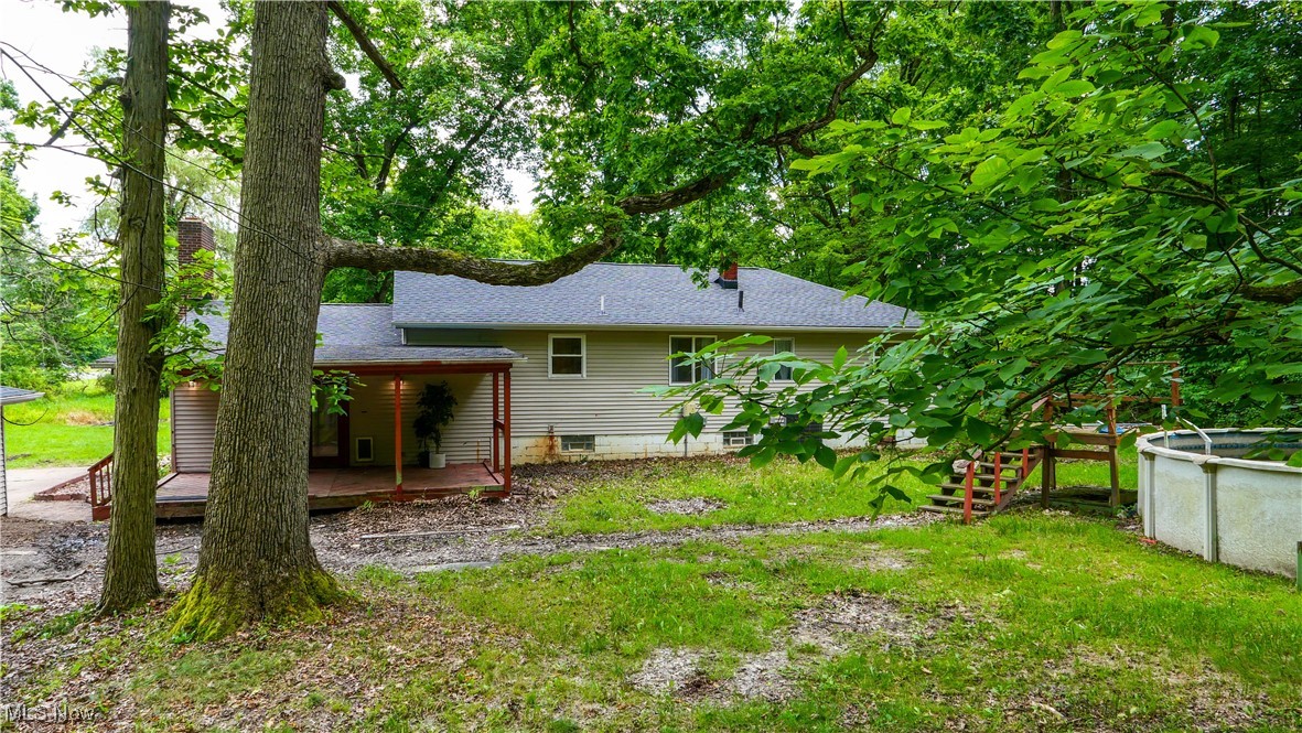 4869 Phillips Rice Road Cortland, OH 44410 - Photo 21 of 33 Rear view of property with a wooden deck, a chimney, and roof with shingles