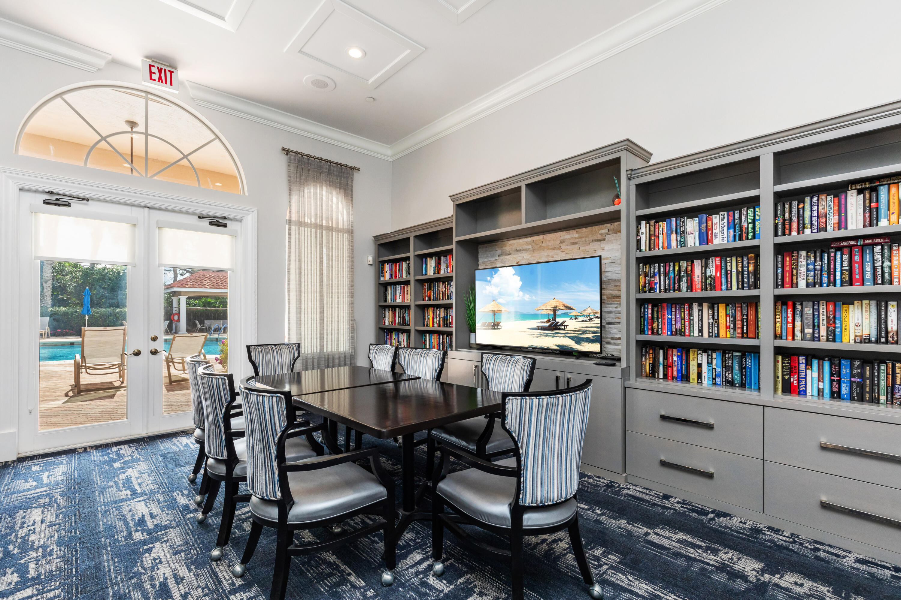 6698 Vía Roma Delray Beach, FL 33446 - Photo 38 of 50 a dining room with furniture and a book shelf