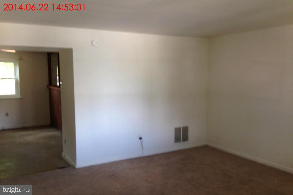 634 Queensgate Road Baltimore, MD 21229 - Photo 2 of 10 an empty room with windows