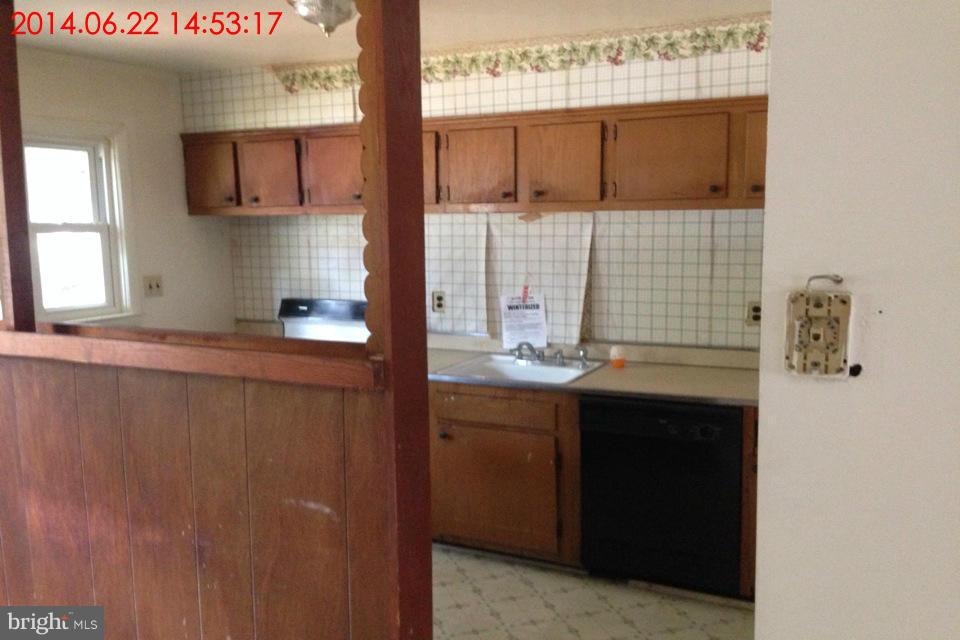 634 Queensgate Road Baltimore, MD 21229 - Photo 3 of 10 a kitchen with a sink and cabinets