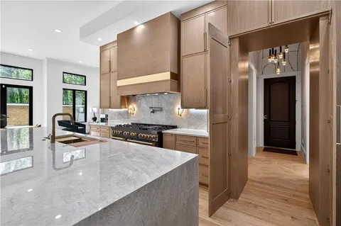 a kitchen with stainless steel appliances granite countertop a sink and cabinets