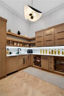 a living room with furniture a flat screen tv and kitchen view