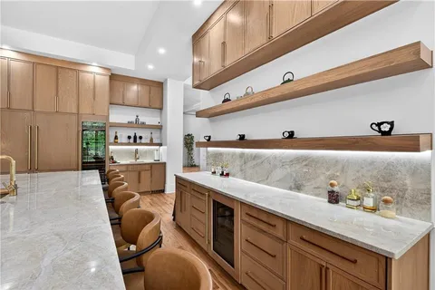 a bathroom with a double vanity sink a toilet a mirror and shower