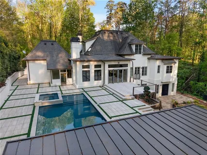 a view of a house with wooden floor roof and sitting area