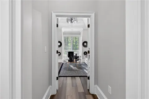 a living room with furniture and floor to ceiling window