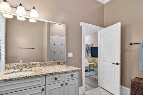 a bathroom with double vanity sinks and a mirror