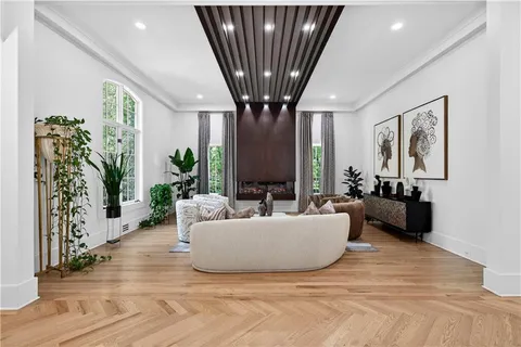 a living room with furniture and a chandelier