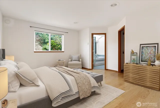 a bedroom with a bed and a large window