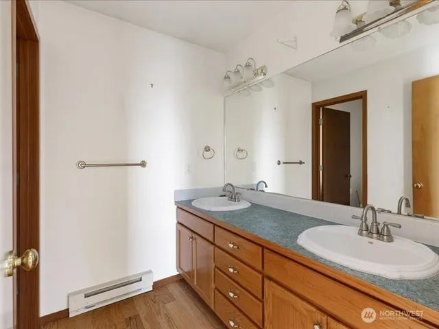 a bathroom with a granite countertop sink and a mirror